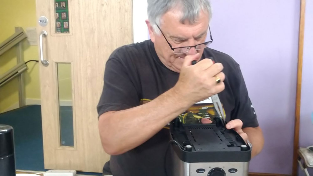 Mick repairing a toaster at the Repair Café in Crowborough