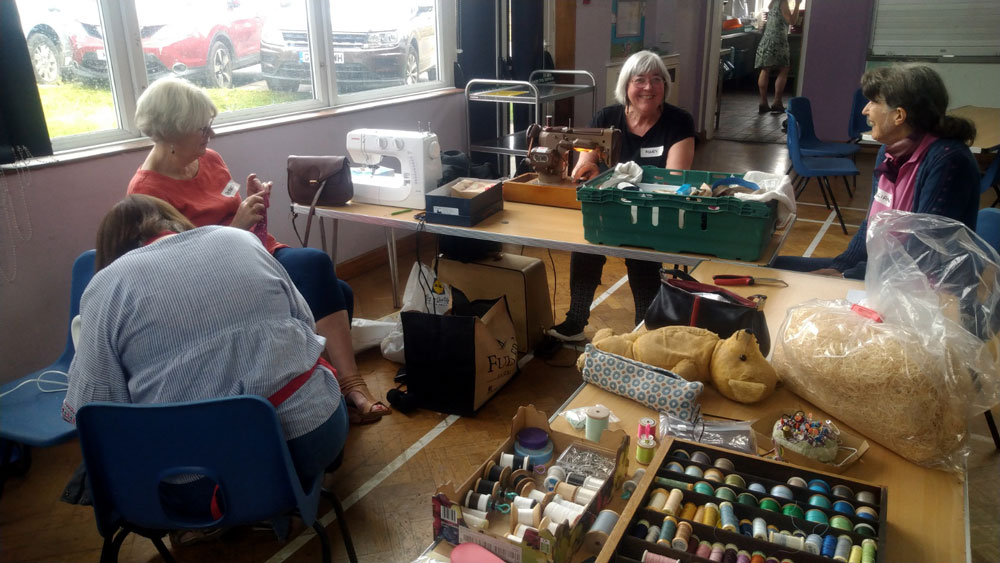 ladies on the textile fabric work station at the Crowborough Repair Café on 2nd July 2022